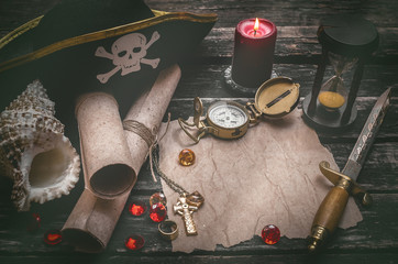 Pirate captain table with crumpled paper page with copy space for treasure map, golden compass,...