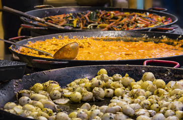Traditional Hungarian foods (stewed vegetables and meat, goulash, ham, flat cake and sausages) at a street fair stand on the Vorosmarty square, Budapest, Hungary