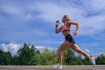 Fit woman running fast for sport on sunny day