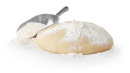 Raw dough and scoop with flour on white background