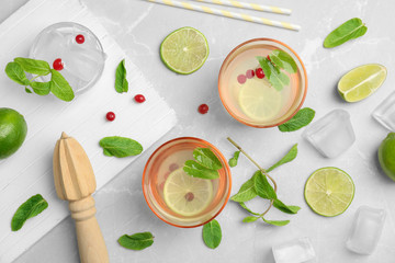 Flat lay composition with delicious natural lemonade on light background