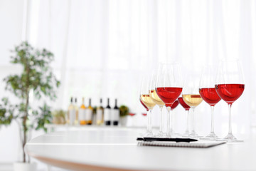 Glasses with delicious wine on table indoors