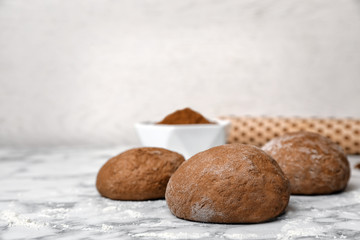 Raw rye dough on table against light background
