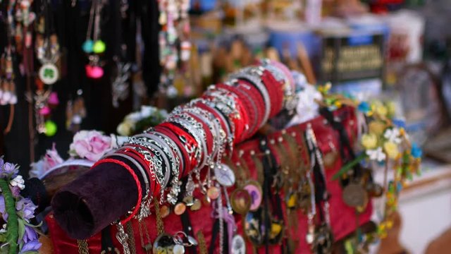 Young woman chooses souvenirs in the market.