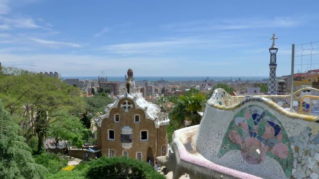 Tilt up view from bench Mosaics to Barcelona's skyline as seen from Park Guell