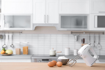 Products, mixer and blurred view of kitchen interior on background