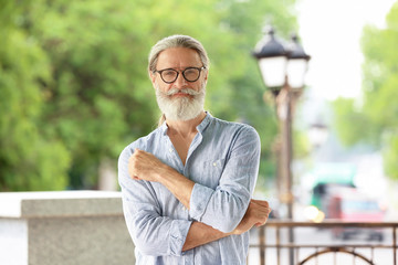 Portrait of handsome bearded mature man, outdoors