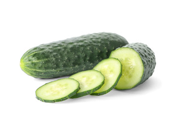 Whole and sliced fresh cucumbers on white background