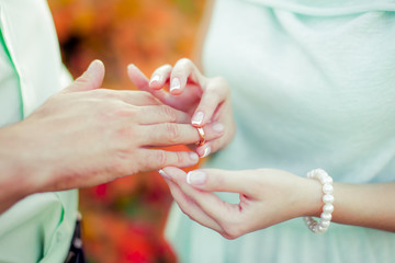 wedding ceremony puts a ring on the finger of the groom and the bride offering an engagement happy moment