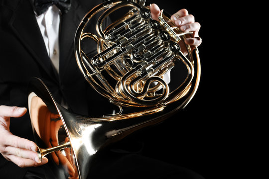 French horn player hands. Hornist playing horn