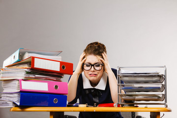Depressed businesswoman sitting at desk