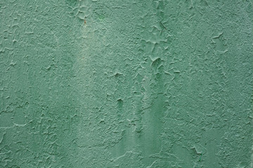 Paint smudges on the surface. Old green background. Painted metal surface. Peeling old green paint