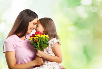 Happy Mother and daughter with flower