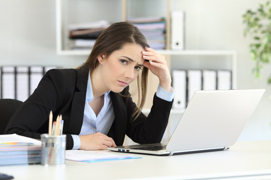 Worried office worker looking at camera