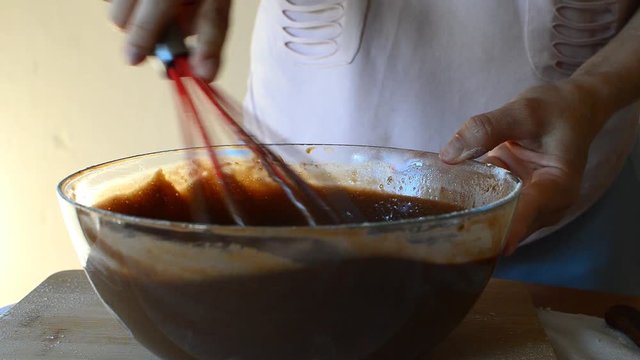 stirring chocolate dough for baking mafin