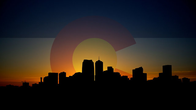Denver Skyline Sunrise with Colorado Flag in Sky