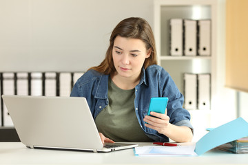 Intern working with a phone and a laptop