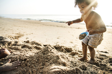 Little kid playing at the beach