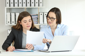 Office workers coworking comparing documents