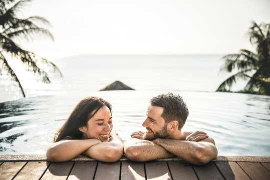 Couple Relaxing In A Swimming Pool