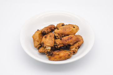 Fried chicken on white plate with white background, asia food, unhealthy food