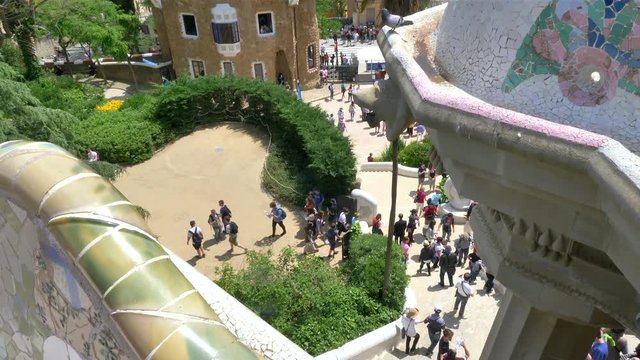 Reveal shot from bench Mosaics to Barcelona's skyline as seen from Park Guell