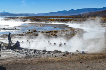 Uyuni, Bolivia - Sept 10, 2015: Tourists relaxing in the volcanic Aguas Calientes hot springs in the Reserva Eduardo Avaroa