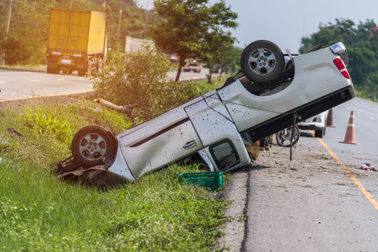 A Traffic Accident Happens On Motorway Highway, One Small Truck Capsizes Because Poor Condition Ties Blow Out. Survivor Guilt,  Car Insurance Survivor Guilt.