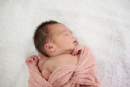 Newborn sleeping on soft blanket