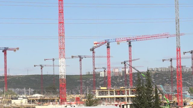 Building Under Construction, Crane and bamboo scaffolding used for the construction of a skyscraper,