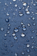 Drops of water on blue waterproof cloth