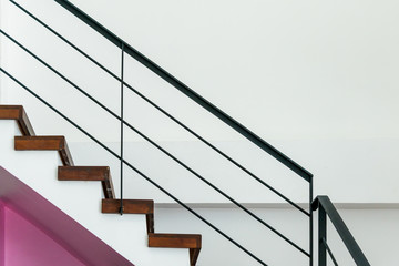 Stairway with metallic banister in a new modern building.