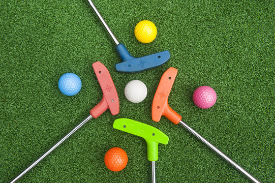 Four Mini Golf Putters with Balls