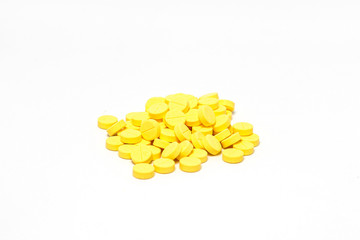 Yellow medicine pill cure heal drug group close up isolated on white background