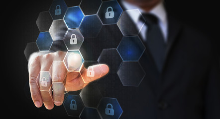 Businessman touching lock icon on binary code and circuits background. Cyber security concept.