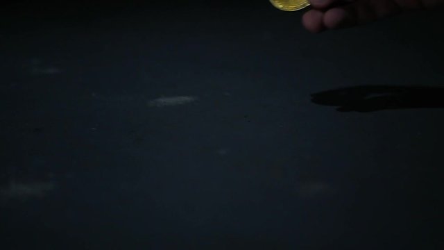Someone picking up a Bitcoin.