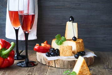 Red wine and smoked cheese on a wooden table