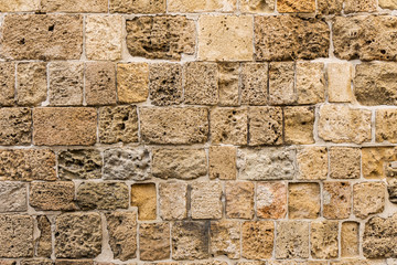 ancient natural stone wall as a texture or background.