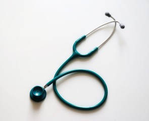 Green stetoscope on white background