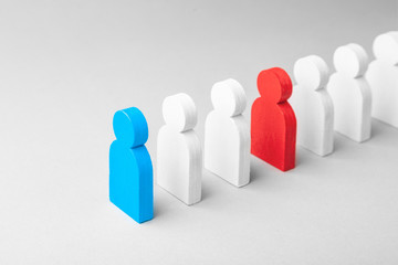 Concept leader of the business team indicates the direction of the movement towards the goal. Crowd of white men goes for the leader of the blue color and  bad conflicting employee of  red color