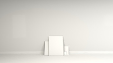 Blank white posters in white frames standing on the floor