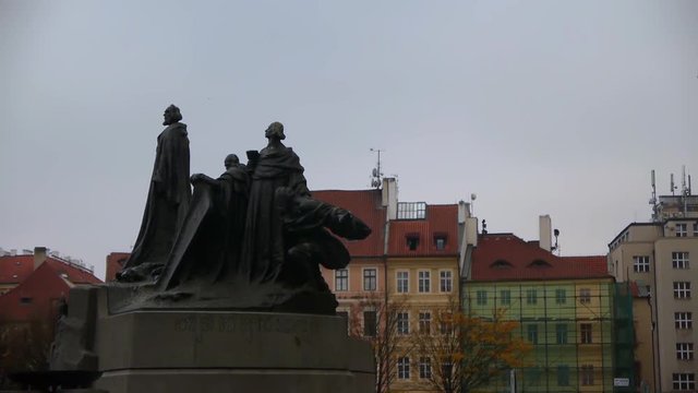 Wide shot of the Jan Hus Monument in the square on a rainy day in Prague