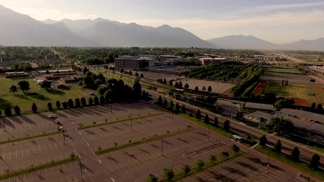 A long aerial approach to the Utah Valley University campus from the north-west side of the campus in the early morning