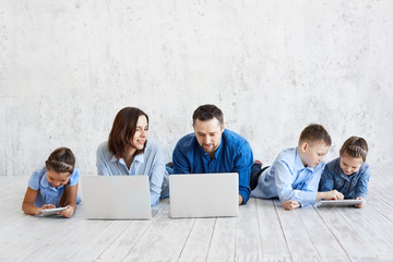 Large family with gadgets. Parents and children at laptops