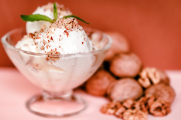 Vanilla ice cream in bowl and walnuts