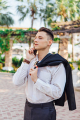 Young businessman talking on his phone outdoors