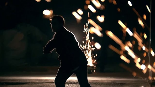 A man changes his legs in a jump, the lights of the night city, slow-motion