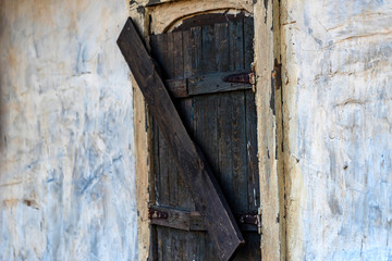 Fototapeta na wymiar Old wooden window of abandoned buildig