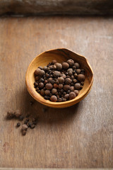 Aromatic black pepper mix on wooden background