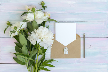 envelope and letter. Peonies on a wooden background. Texture. A photo for social networks. Flat lay desks